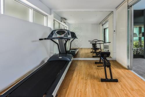 a gym with two treadmills and two exercise bikes at Villa Sonata Phuket in Chalong 