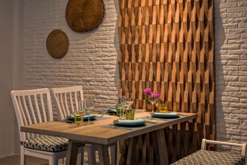 a wooden table with two chairs and a dining room at Villa Sonata Phuket in Chalong 