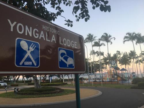 a street sign in a park with a roller coaster at Yongala Lodge by The Strand in Townsville
