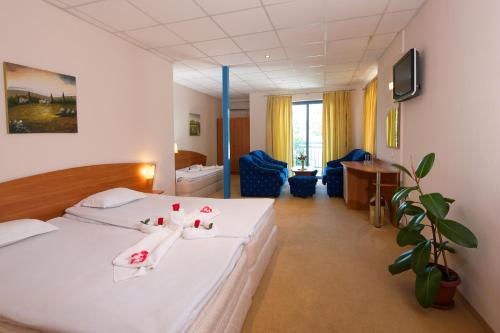 a hotel room with two beds and a desk at Paloma - in the center of the city in Sunny Beach
