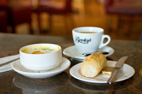 two cups of coffee and a bowl of soup and a piece of bread at Sligo Park Hotel & Leisure Club in Sligo