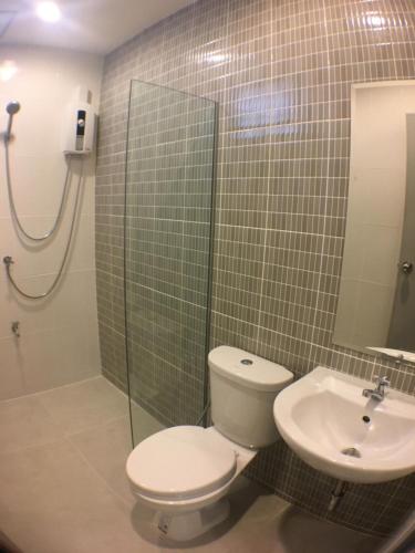 a bathroom with a toilet and a sink at 28 Place in Bangkok