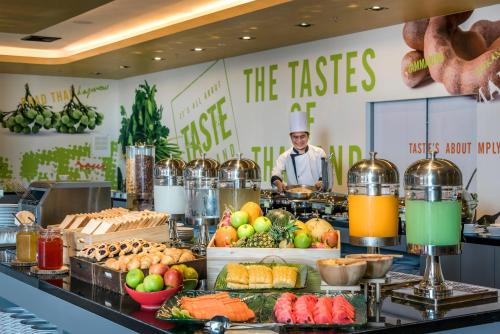 a chef is standing behind a buffet of food at ibis Bangkok IMPACT in Nonthaburi
