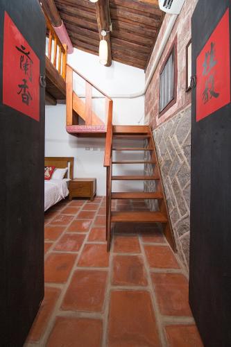 a room with a staircase and a room with a bed at Patio Moonlight in Jincheng