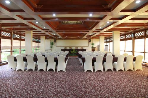 a room with rows of white chairs in a hall at The Jayakarta Yogyakarta Hotel & Spa in Yogyakarta