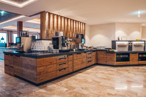 a large kitchen with wooden cabinets and a counter top at Familienresort Buchau in Maurach