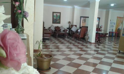 a lobby with a checkered floor and a waiting room at Dynasty Suite in Aley