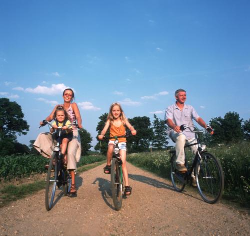 a group of people riding bikes on a dirt road at Hotel De Boskar Peer in Peer