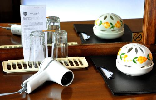 a wooden table with a hair dryer and bowls on it at Margarita Hotel in Kythira