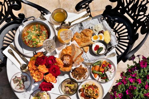 a table with a lot of food on it at Villa Brown Jerusalem, a member of Brown Hotels in Jerusalem