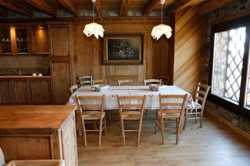 a dining room with a table and chairs at Albergo Diffuso Zoncolan in Ovaro