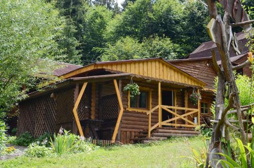 a log cabin in the woods with trees at Zarinok in Pilipets
