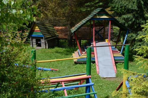 a playground with a slide and a play house at Zarinok in Pilipets