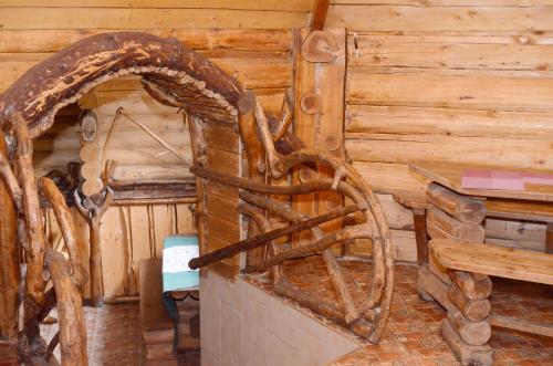 a room with a wooden cabin with a wooden chair at Zarinok in Pilipets