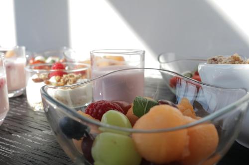 a glass bowl filled with fruit on a table at B&B For 2-Wellness For 2 in Bruges