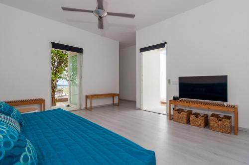 En eller flere senge i et værelse på Bonaire Bay View Villa