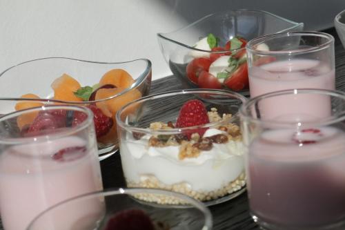 a group of glasses of food with fruit and yogurt at B&B For 2-Wellness For 2 in Bruges