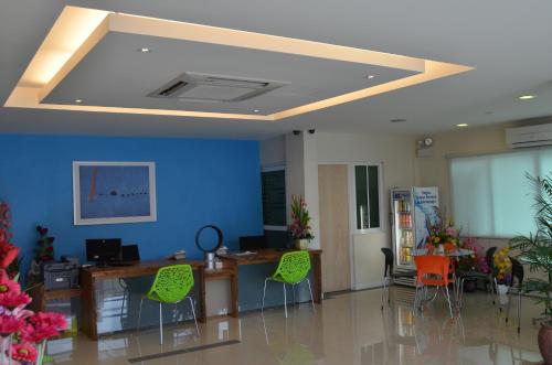 a living room with a blue wall and a ceiling at Hotel Asia in Kuah