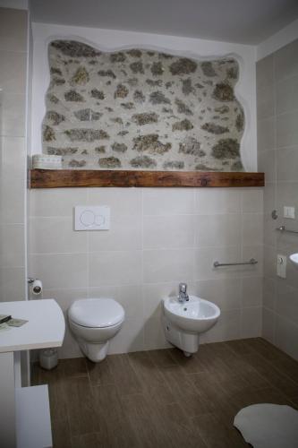 a bathroom with a toilet and a sink at Albergo Diffuso Zoncolan in Ovaro