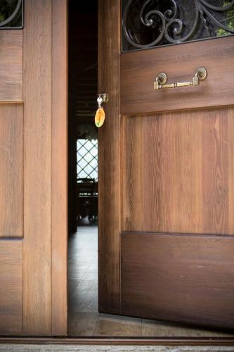 an open wooden door with a tag on it at Albergo Diffuso Zoncolan in Ovaro