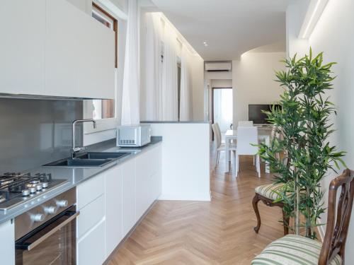 
a kitchen with a stove a sink and a refrigerator at Luxury Apartment On Grand Canal in Venice
