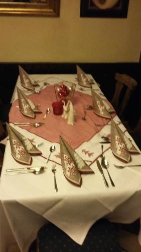 a table witheating utensils on a white table cloth at Landhotel Zur alten Post in Lohr am Main