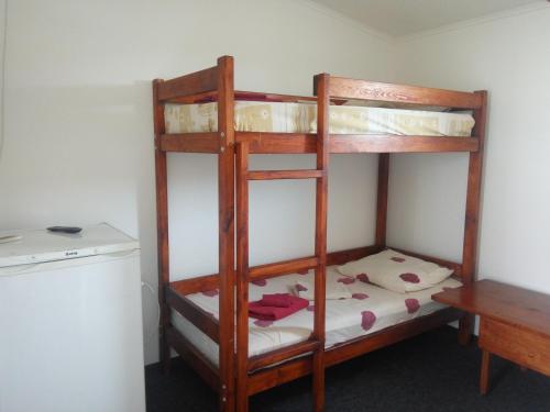two bunk beds in a room with a desk at Hotel Vivat in Velikodolinskoye