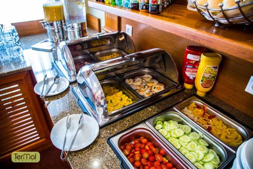 a kitchen counter with trays of food on a counter at Penzion Termal in Bojnice