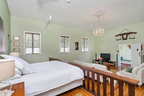 a bedroom with a large bed and a living room at The Church in Yungaburra