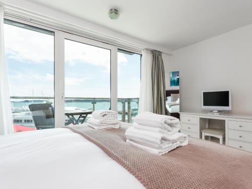 a bedroom with a bed with a view of the ocean at Panorama in Poole