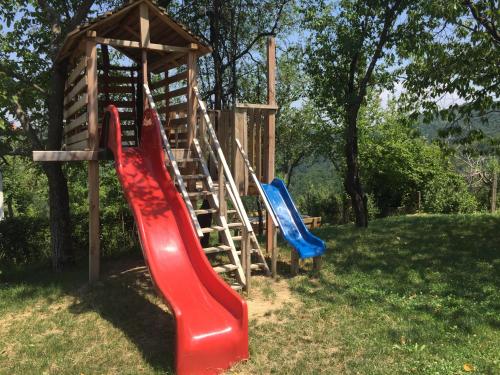a playground with two slides and a wooden structure at Арт комплекс Горски дом - Трявна in Tryavna