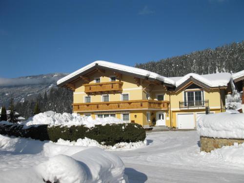a house covered in snow in front of it at Haus Anni in Radstadt