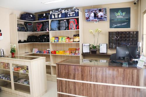 a shop with a counter and shelves of bags at Hotel Vale das Artes in Embu