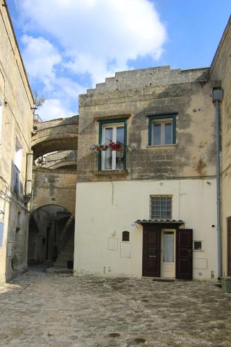 an old building with a window and a balcony at Antica Civita Luxury Room in Matera