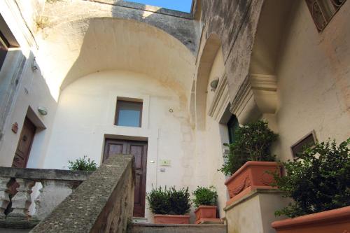 an entrance to a building with a door and some plants at Antica Civita Luxury Room in Matera