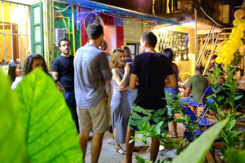 a group of people standing around in a room at Yellow House Hostel Huizhou West Lake in Huizhou