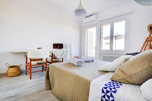 a bedroom with a bed and a table and chairs at VILLA ES TORRENTÓ (HIGH FLYER) in Palma de Mallorca