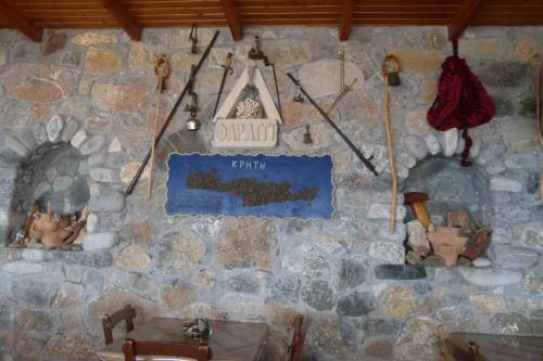 a stone wall with a sign that saysfaith on it at Faragi in Agia Roumeli