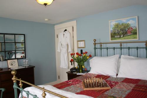 a bedroom with a bed with a chess board on it at Sugar Hill Inn in Sugar Hill