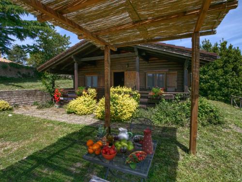 a table of fruit in front of a cabin at Belvilla by OYO Chalet Graffi in Civitella dʼAgliano