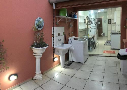 a bathroom with a sink and a toilet in a room at Casa Anhembi/Center Norte in São Paulo