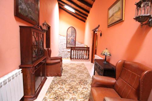 a living room with a couch and a chair at Posada de Bielva in Bielva