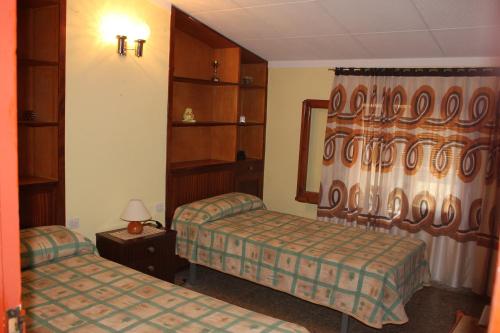 a hotel room with two beds and a window at Can Carreras in Albanya