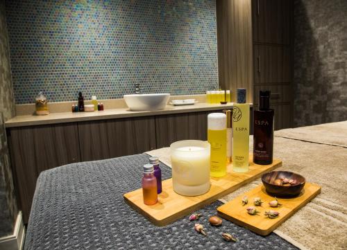 a table with a tray with a drink and a bowl of food at Mallory Court Country House Hotel & Spa in Leamington Spa