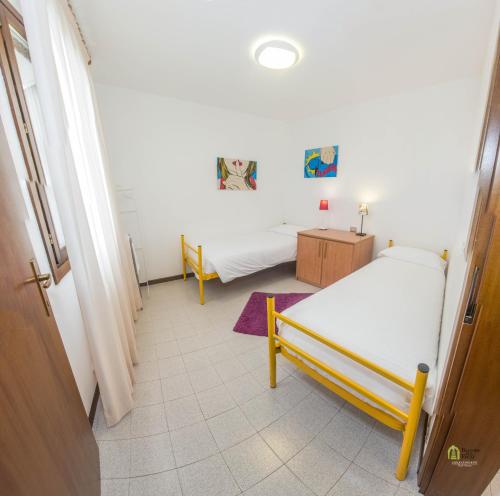 a room with two beds and a hallway at Albergo Diffuso Balcone sul Friuli in Clauzetto