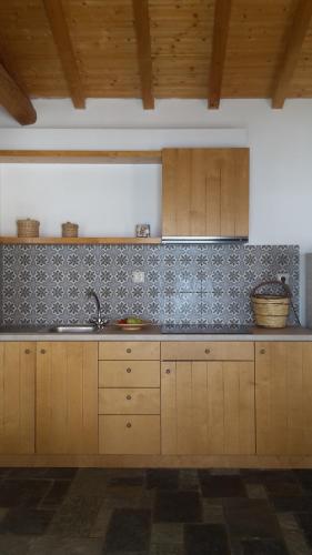 a kitchen with a sink and a counter top at Island Apartments in Psilí Ámmos