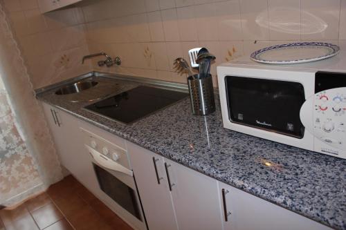 A kitchen or kitchenette at Mare Nostrum Beach Vistas al Mar Terraza Fibra Optica, , Aparcamiento