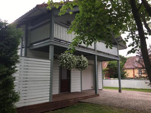 a house with a balcony on the front of it at Väike-Mere Villa in Haapsalu