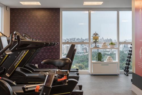 a gym with a row of treadmills at Intercity Porto Alegre Cidade Baixa in Porto Alegre