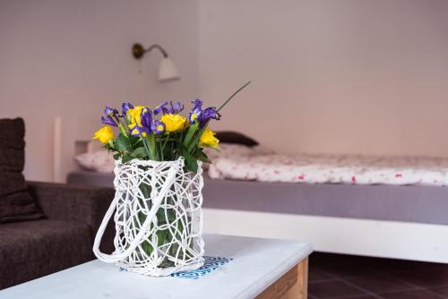 a vase filled with flowers sitting on a table at Apartmany Rabi in Raby